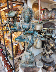 Decorative metal figurines of Buddha in a meditative pose on a shop window
