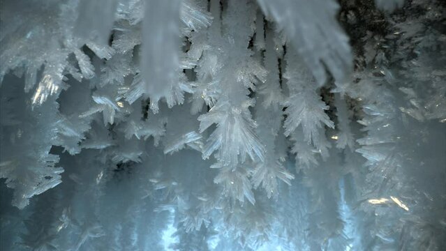 Beautiful crystal icicles, ice snowflakes on stalactites inside frozen cave 