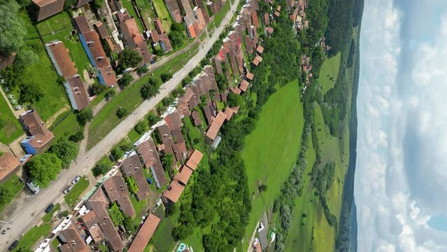 Viscri Village - Romania, perspective from drone. Beautiful country side, green fields. Vertical footage