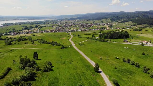 Lakeside village, meadows and pastures, southern Poland landscape, wide panoramic aerial