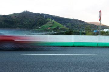 Long exposure image of a car driving fast on the highway
