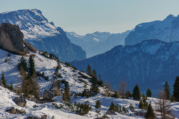 Idyllic view at dolomite mountain landscape during winter with snow covered peaks at pass road of...