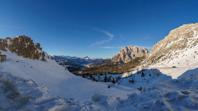 Idyllic view at dolomite mountain landscape during winter with snow covered peaks at pass road of Valparola, South Tirol, Italy