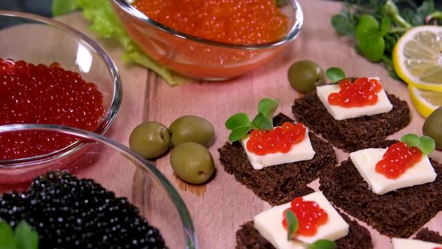 Sandwiches with red and black caviar on white and Borodino bread