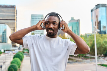 attractive african american man listening to music with headphones. portrait of young black man...