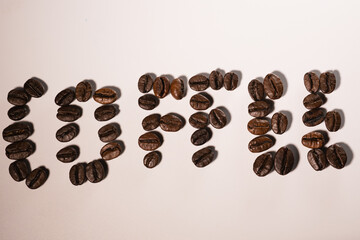 Coffee beans and the inscription coffee on a white background.
