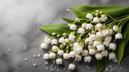 Lily of the Valley flowers with water droplets on marbled surface 