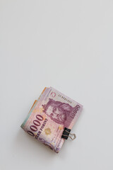 Banknotes held together with tweezers.