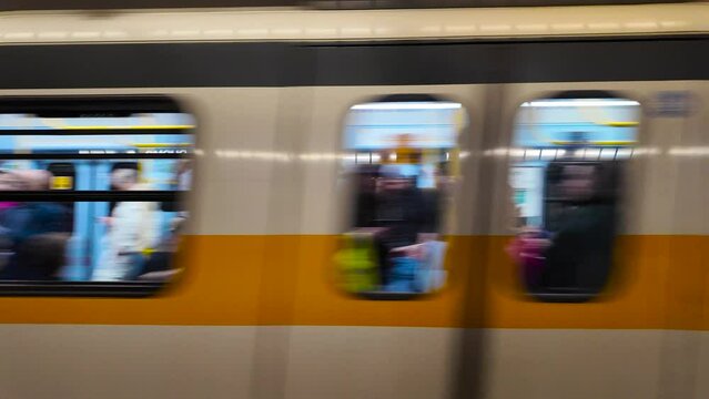  Sign Duomo metro station in Milan. The metro train arrived at Duomo station. Subway car full of tourists