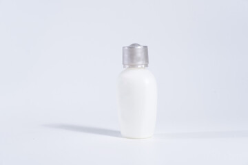 White plastic cosmetic lotion bottle mock-up with cap.on white background