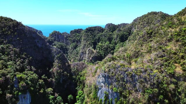 Primeval jungle hills island phi phi island. Lovely aerial top view flight descending drone
4k
