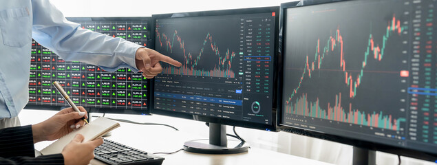 A cropped close-up image of professional smart trader hand pointing at financial growth graph while...