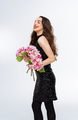 Portrait of happy young woman holding bouquet of flowers isolated over white background