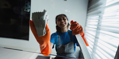 Housekeeping woman wiping the table in the living room House cleaning service concept