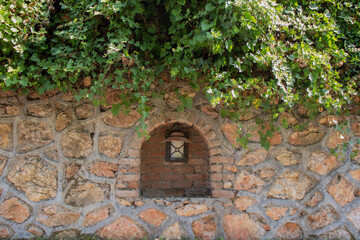 lighting hidden in stone wall. ivy on the stone wall.