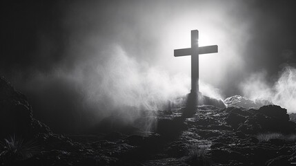 a cross on a hill with fog