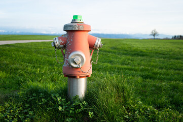 Fototapeta na wymiar Fire hydrant in a green field