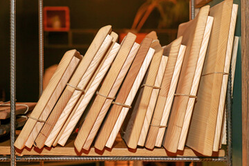 Stack of old books with paper covers on wooden shelf - 767019146