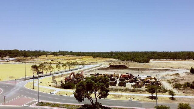 Wide view of large construction vehicles at new housing development Catalina Green, Perth