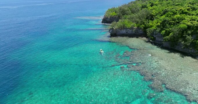 Boat Cruising On Tropical Island Of Moso In Efate, Shefa Province, Vanuatu. aerial ascending shot