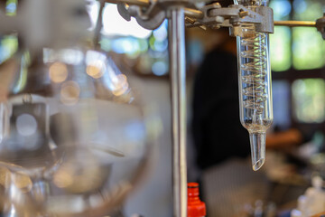 selective focus glass tube spool for liquid distillation equipment In the refreshing drink shop Use scientific experiment equipment to make drinks for sale.