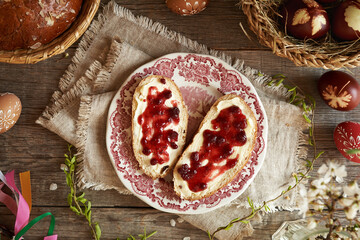 Two slices of traditional Czech sweet Easter cake called mazanec with butter and marmalade on a table