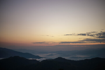 Background image of a morning landscape on a mountaintop with mountains and a sea of ​​mist...