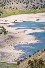 The rugged coastline of Lake Kulikalon from the height of the pass in the Fan Mountains in Tajikistan