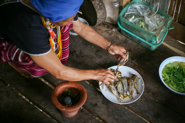 Selective focus Many fried mackerel are about to be eaten. Hilltribe forest people in Thailand