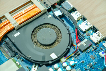 Close up old disassembled laptop after cleaning the cooler system, Reviving technology, specialist...
