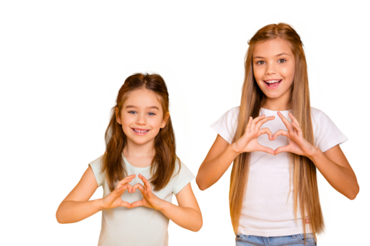 Portrait of two nice attractive lovely sweet cheerful cheery positive caucasian girls having fun showing healthy heart isolated over bright vivid shine yellow background - Powered by Adobe