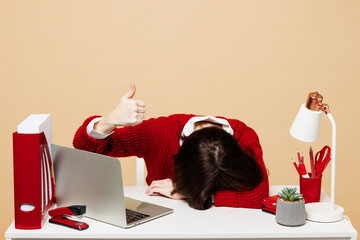 Young tired employee business woman wear red sweater shirt sit work at office desk with pc laptop...
