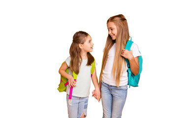 Portrait of two nice attractive lovely cheerful cheery pre-teen girls with colorful backpacks...
