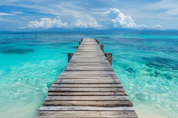 Tuinposter Wooden pier leading to the ocean with a white sand beach and turquoise water, tropical island background, copy space for text in a wide format in the style of tropical island background. © Denis