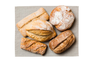 Freshly baked delicious french bread with napkin isolated on white background top view. Healthy white bread loaf