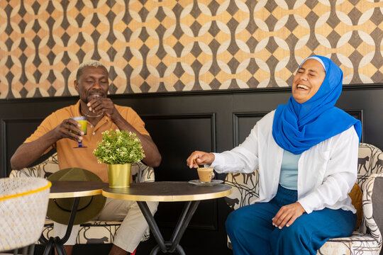 Enjoying coffee and laughter in a diverse setting