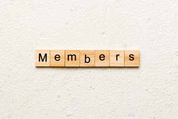 Members word written on wood block. Members text on cement table for your desing, concept