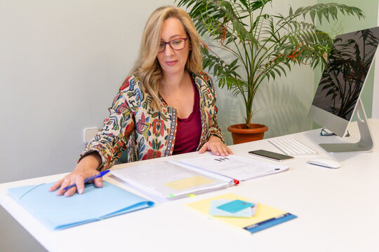 Professional woman reviewing documents at office desk