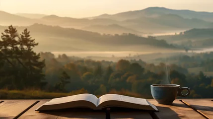 Fototapeten An open book and a coffee cup are placed on a wooden table next to a beautiful hill view in dusk time as a background with a relaxed ambience. Background for relaxation, vacation and rest time. © Kanlayarawit