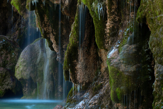 Serene waterfall on mossy rocks in a tranquil setting