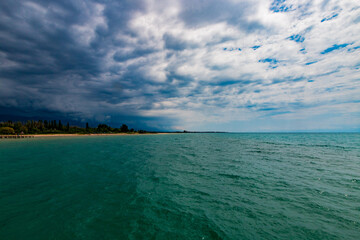 Famous Issyk-Kul Lake in Kyrgyzstan on a summer day. The shoreline in the picture is near the "Raduga" pension