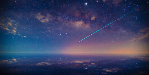 Beautiful night filled with many stars twinkling in the night sky. Stardust in deep universe.A meteor is falling from the sky. Shooting star and nebula in starry night sky.