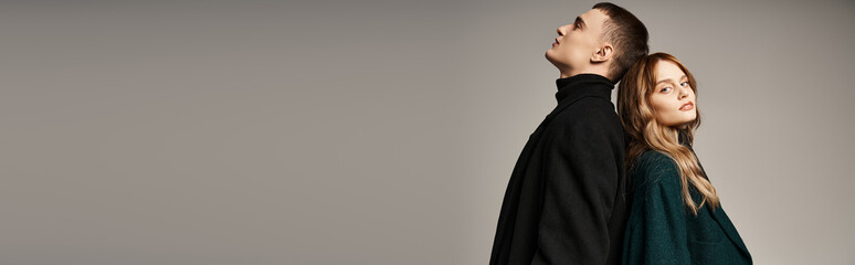 stylish man in coat posing lovingly next to his beautiful girlfriend who looking at camera, banner