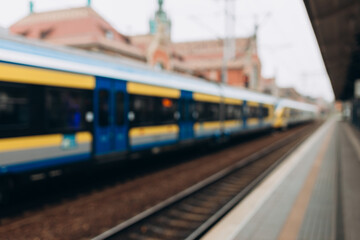 Blurry background image of a train and station. Long-distance train. Touristic and transportation concepts.