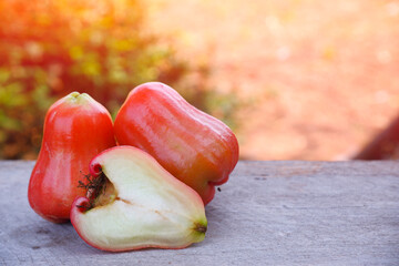 Fresh, rose apples, red slice on wooden with nature background Healthy fruits, organic and juicy,...