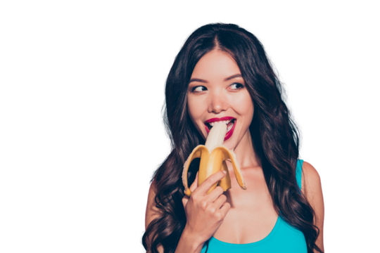 Close-up portrait of nice foxy cunning sweet lovely adorable glamorous delicate charming wavy-haired lady holding biting banana red lips isolated over pink pastel background