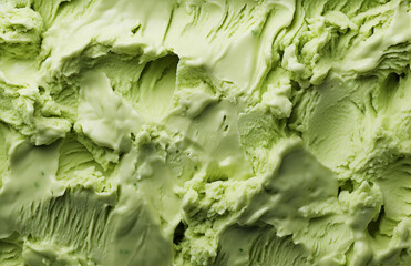 Closeup of homemade green pistachio or herbal mint ice cream texture. Frozen joghurt macro. Summer delicious sweet cool dessert. Gourmet food web banner, backdrop. Dairy product. Top view.