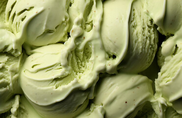 Fototapeta premium Closeup of homemade green pistachio ice cream texture, with little pieces of chopped nuts. Frozen joghurt macro. Summer delicious sweet dessert. Gourmet food web banner. Dairy product. Top view.