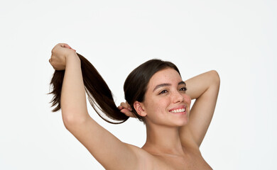 Obraz premium Happy pretty young adult woman, smiling brunette girl model looking away holding long healthy straight smooth hair in hands posing for beauty portrait isolated on white background. Hair care treatment