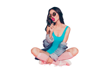 Full size lady sit on floor with her wave brunette hair she eat sugar sweet caramel sucker on stick...